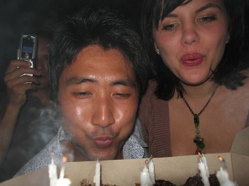 Adults blowing out candles